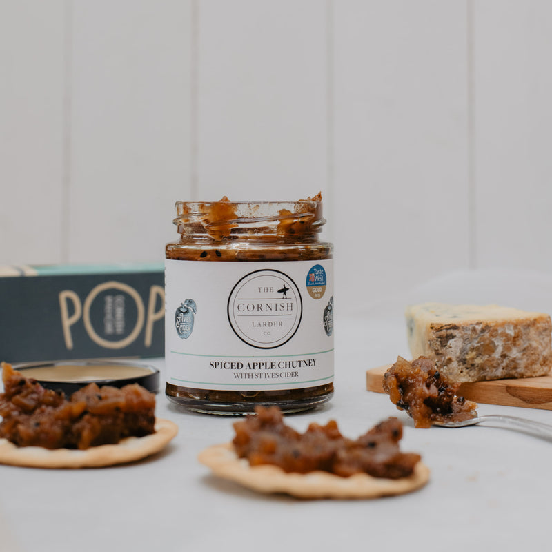 apple chutney jar with chutney on crackers in front of the jar