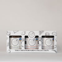 Cheeseboard gift box covered in cheeseboard illustrations such as apples, grapes, cheese, onion and herbs.