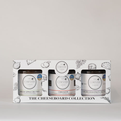 Cheeseboard gift box covered in cheeseboard illustrations such as apples, grapes, cheese, onion and herbs.