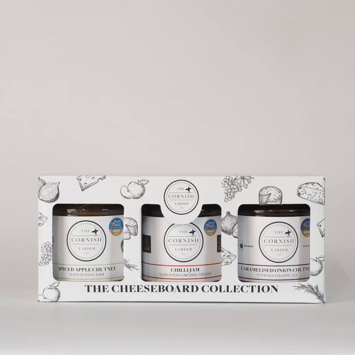 Cheeseboard gift box covered in cheeseboard illustrations such as apples, grapes, cheese, onion and herbs.
